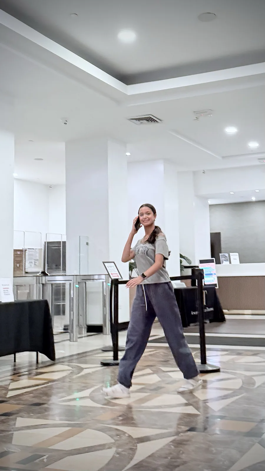 Grace Ramos smiling while walking through a bright lobby